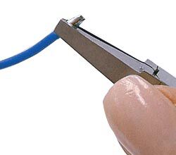 Pliers compressing the cord end